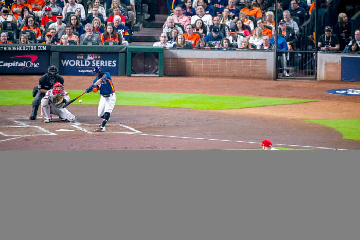 Jose Altuve hits a leadoff double in Game 2 of the World Series.